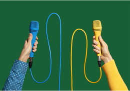 Two hands holding blue and yellow cabled microphones on a solid green background, symbolizing voice communication and podcasts.